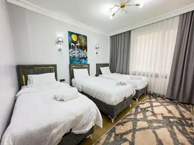 a bedroom with two beds and a painting on the wall at Sisli Apartments Holiday441 in Istanbul