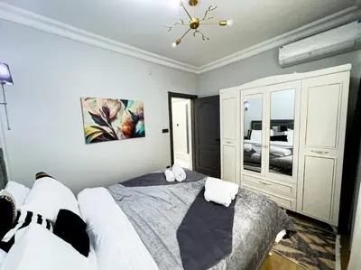 a bedroom with a large bed and a chandelier at Holiday 5 4 Sisli 3 in Istanbul
