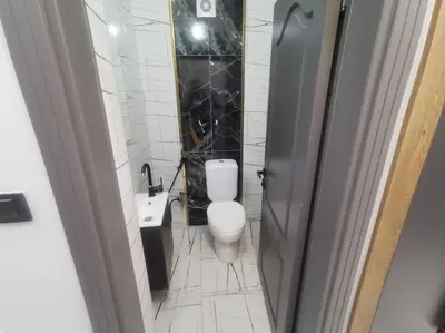 a white bathroom with a toilet and a sink at Holiday 5 4 Sisli 3 in Istanbul