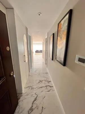a hallway with marble floors and paintings on the walls at Sense Suite Residence-19 in Istanbul