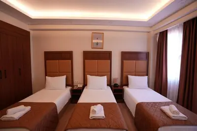 two beds in a hotel room with towels on them at Keeper in Istanbul