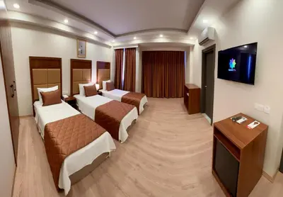 a hotel room with two beds and a television at Keeper in Istanbul