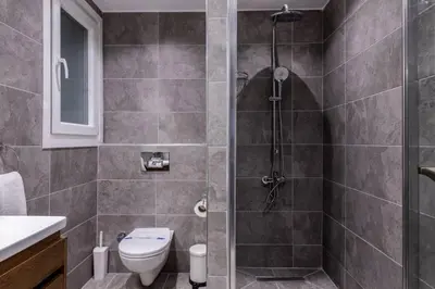 a bathroom with a shower and a toilet at Cute Private Garden 2BD2Bath Quaint Home! #366 in Istanbul