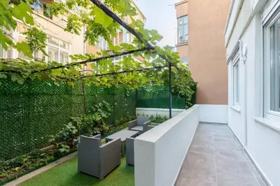 an outdoor seating area on a balcony of a building at Cute Private Garden 2BD2Bath Quaint Home! #366 in Istanbul