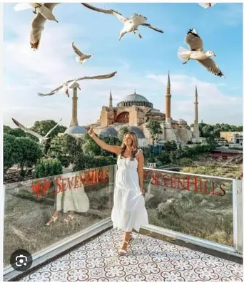 a woman standing in front of a wall with birds at Özdemir Apart - Sultanahmet in Istanbul