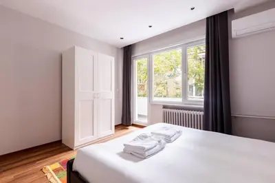 a bedroom with a bed with white sheets and a window at Bright Charming Modern 3BD2Bath Balcony! #367 in Istanbul