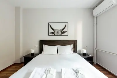 a bedroom with a large white bed with horns on the wall at Bright Charming Modern 3BD2Bath Balcony! #367 in Istanbul