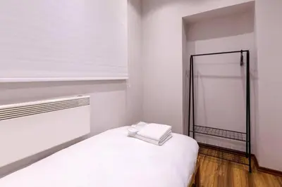 a white bedroom with a bed and a mirror at Bright Charming Modern 3BD2Bath Balcony! #367 in Istanbul