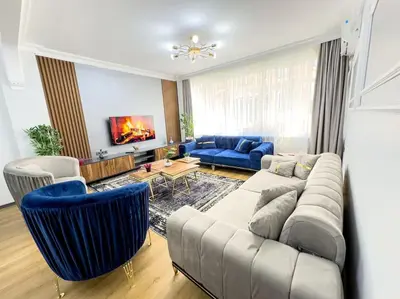 a living room with a couch and blue chairs at Sisli apartment 6 4 4 in Istanbul