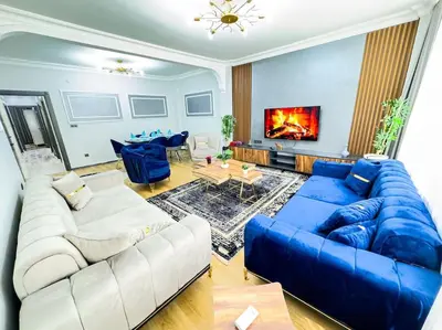 a living room with a blue couch and a blue sofa at Sisli apartment 6 4 4 in Istanbul