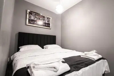 a bedroom with a large bed with white sheets at opera wall suite in Istanbul