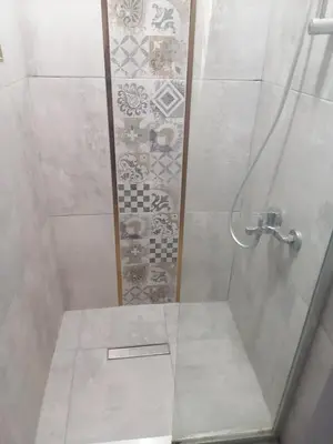 a bathroom with a shower with a glass door at opera wall suite in Istanbul