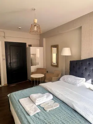 a bedroom with a bed with two towels on it at Taksim Castle Suites in Istanbul
