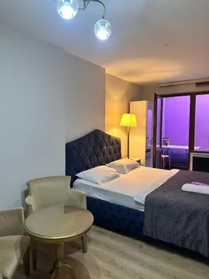 a bedroom with a bed and a table and a chair at Taksim Castle Suites in Istanbul