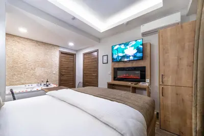 a bedroom with a bed and a bathroom with a tv at Beys Hotel Suites in Istanbul