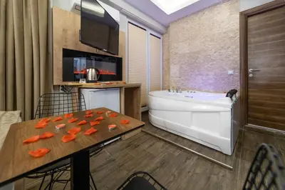 a bathroom with a tub and a table with carrots on it at Beys Hotel Suites in Istanbul