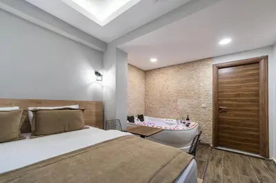 a bedroom with a bed and a bathtub and a tub at Beys Hotel Suites in Istanbul