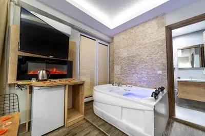 a bathroom with a large tub and a tv at Beys Hotel Suites in Istanbul