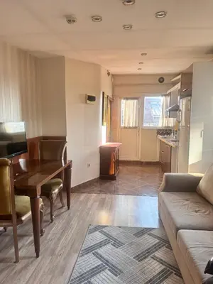 a living room with a table and a couch at taksim white family suites in Istanbul