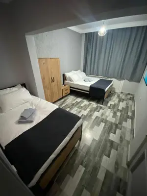 a hotel room with two beds and a window at Pamir Butik Otel in Bursa