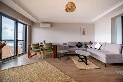 a living room with a couch and a table at Modern Two-Bedroom Flat with Stunning Bosphorus View in Istanbul