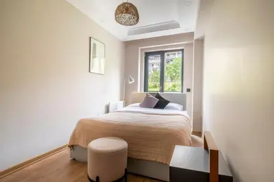 a white bedroom with a bed and a window at Modern Two-Bedroom Flat with Stunning Bosphorus View in Istanbul