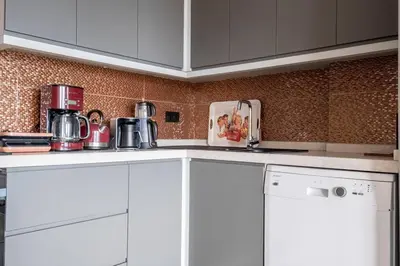 a kitchen with white cabinets and white appliances at Modern Two-Bedroom Flat with Stunning Bosphorus View in Istanbul
