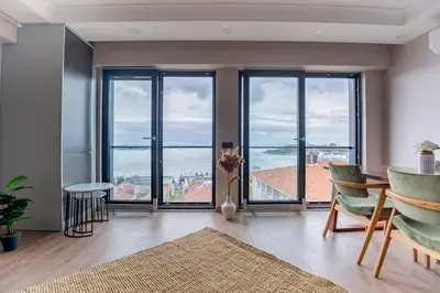 a living room with a view of the ocean at Modern Two-Bedroom Flat with Stunning Bosphorus View in Istanbul