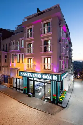 a pink building on a city street at night at Santa Rio Gold Taxim Hotel in Istanbul