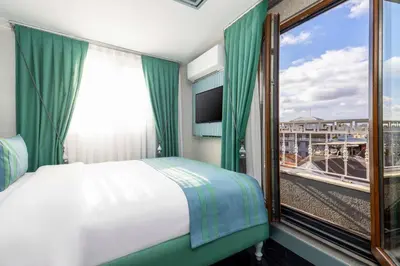 a bedroom with a bed and a window with a view at Santa Rio Gold Taxim Hotel in Istanbul