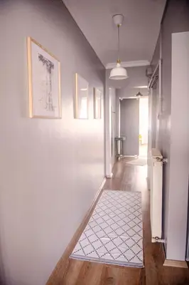 a hallway with white walls and a white rug at A Cozy, Quiet Home with Great View in City Center in Istanbul