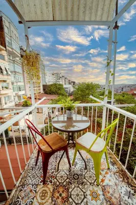a balcony with a table and chairs on a balcony at A Cozy, Quiet Home with Great View in City Center in Istanbul