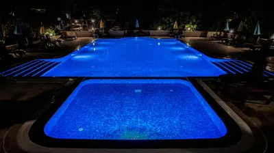 a large swimming pool lit up at night at Fener Motel in Sile