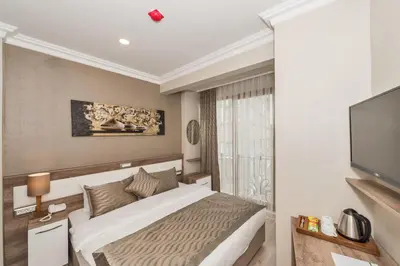 a bedroom with a bed and a flat screen tv at Alphonse Hotel in Istanbul
