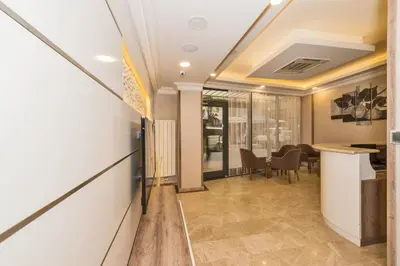 an office with a hallway with a table and chairs at Alphonse Hotel in Istanbul