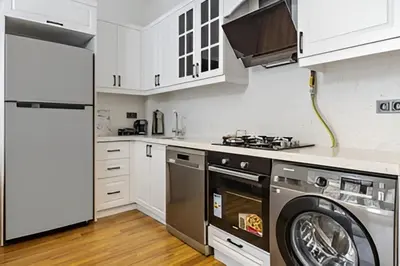 a kitchen with a washing machine and a washer at NIŞANTAŞI JANTY LUXURY, 4 NEW APARTMENTs in Istanbul