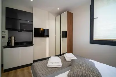 a bedroom with a bed with towels on it at Rusel Park Residence in Bahcesehir