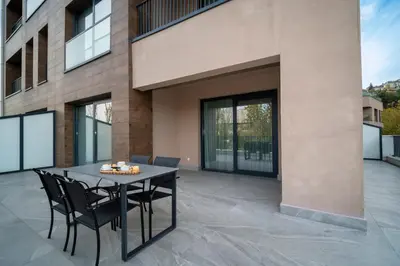 a patio with a black table and chairs at Rusel Park Residence in Bahcesehir