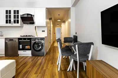 a kitchen and living room with a table and chairs at HEARTH OF DOWNTOWN ,LUXURY 1 NEW APARTMENTs in Istanbul