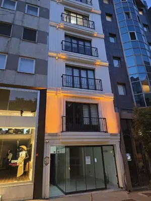 a tallartment building with windows and a store at HEARTH OF DOWNTOWN ,LUXURY 1 NEW APARTMENTs in Istanbul