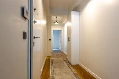 a hallway with white walls and a hallway with a rug at HEARTH OF DOWNTOWN ,LUXURY 1 NEW APARTMENTs in Istanbul