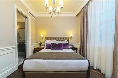 a bedroom with a large bed with purple pillows at Meroddi Bağdatlıyan - 1892 Heritage Rooms by Galata Tower in Istanbul
