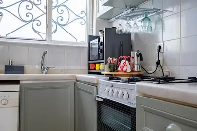 a white kitchen with a stove and a sink at Spacious Dublex in Cihangir in Istanbul
