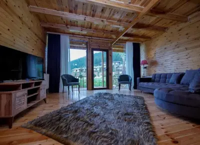 a living room with a couch and a tv at Bisanthe Panorama in Kumbağ