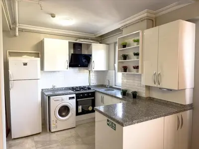 a kitchen with a white refrigerator and a washer at Şişli mado 9 2 3 in Istanbul