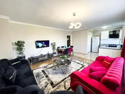 a living room with a red couch and a table at Şişli mado 9 2 3 in Istanbul