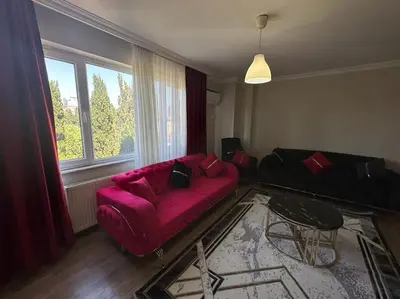 a living room with a red couch and a window at Şişli mado 9 2 3 in Istanbul