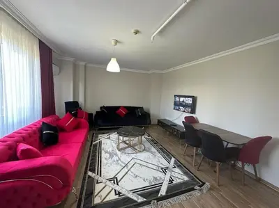 a living room with a red couch and a table at Şişli mado 9 2 3 in Istanbul