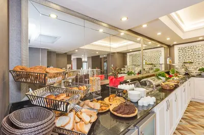 a breakfast buffet with bread and pastries on a counter at Hanna Hotel in Istanbul