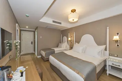 a hotel room with two beds and a table at Hanna Hotel in Istanbul